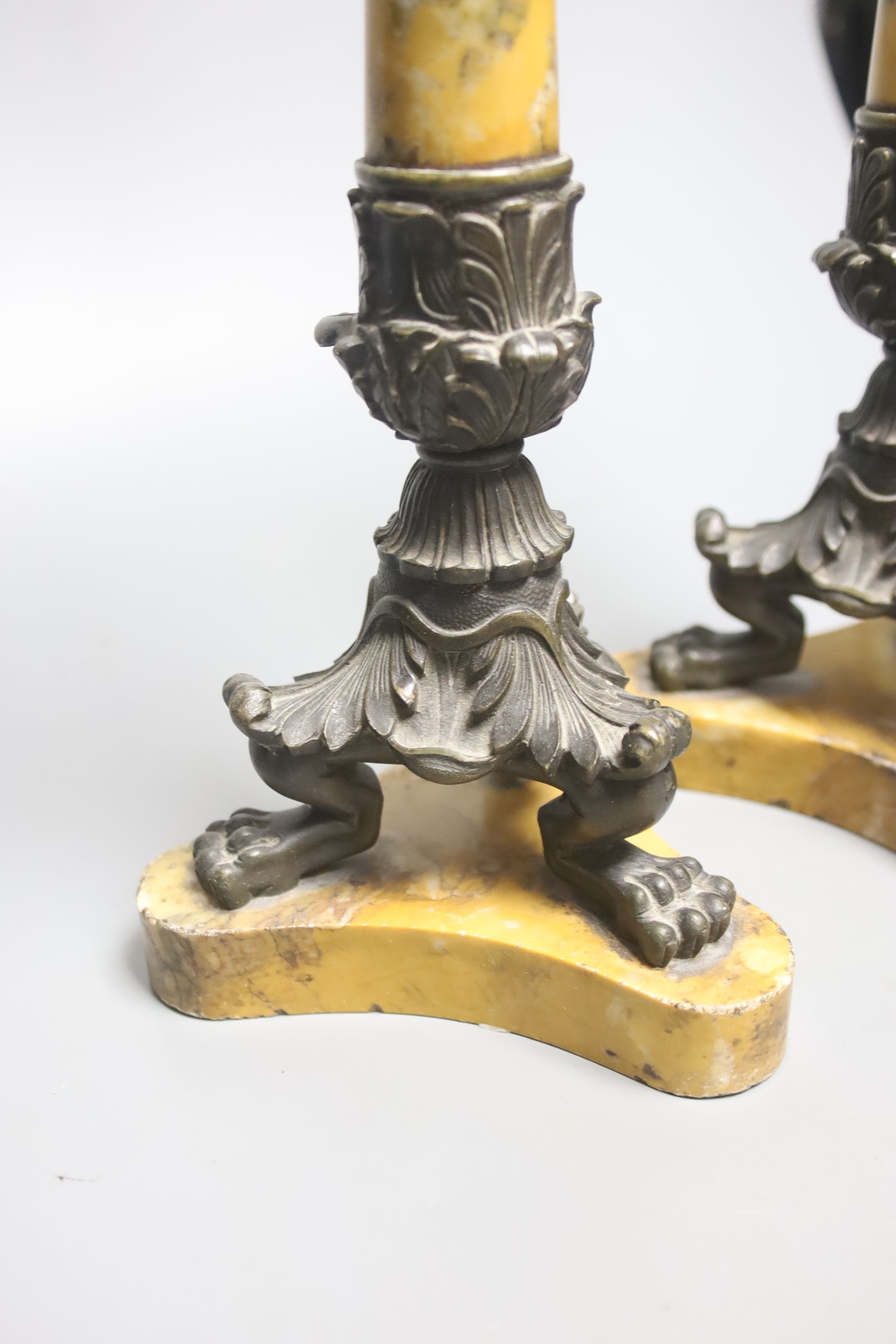 A pair of Empire bronze and Sienna marble candlesticks, height 32cm